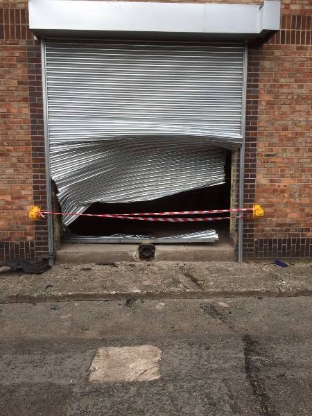 Damaged roller shutter inspected before repair